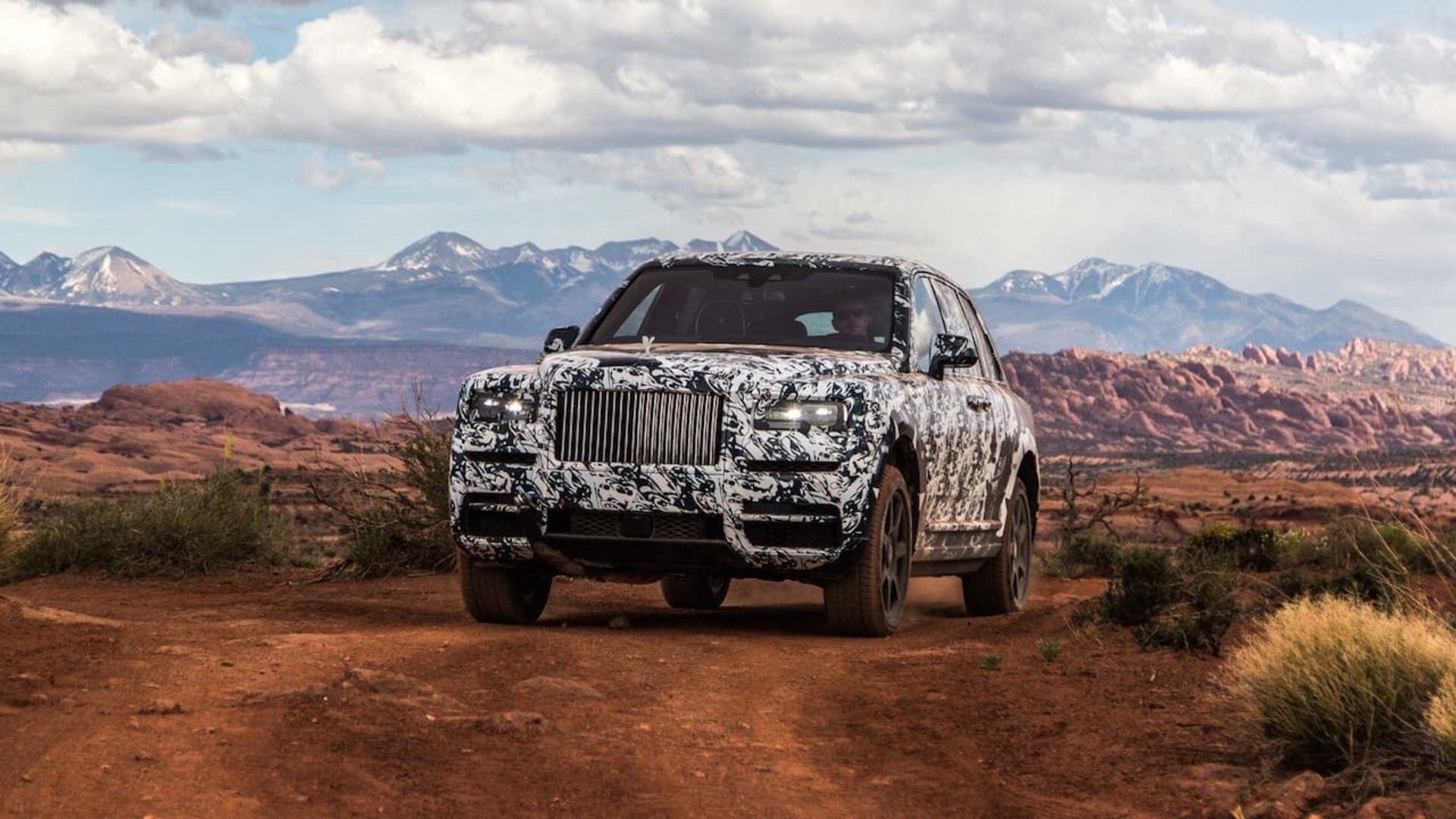 A Rolls-Royce Cullinan car driving on a uneven surface in United States