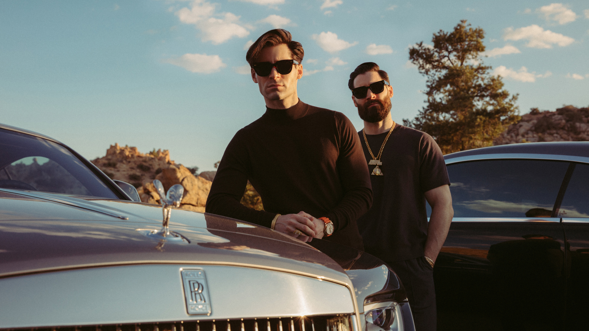 The Golden Brothers next to their Rolls-Royce car