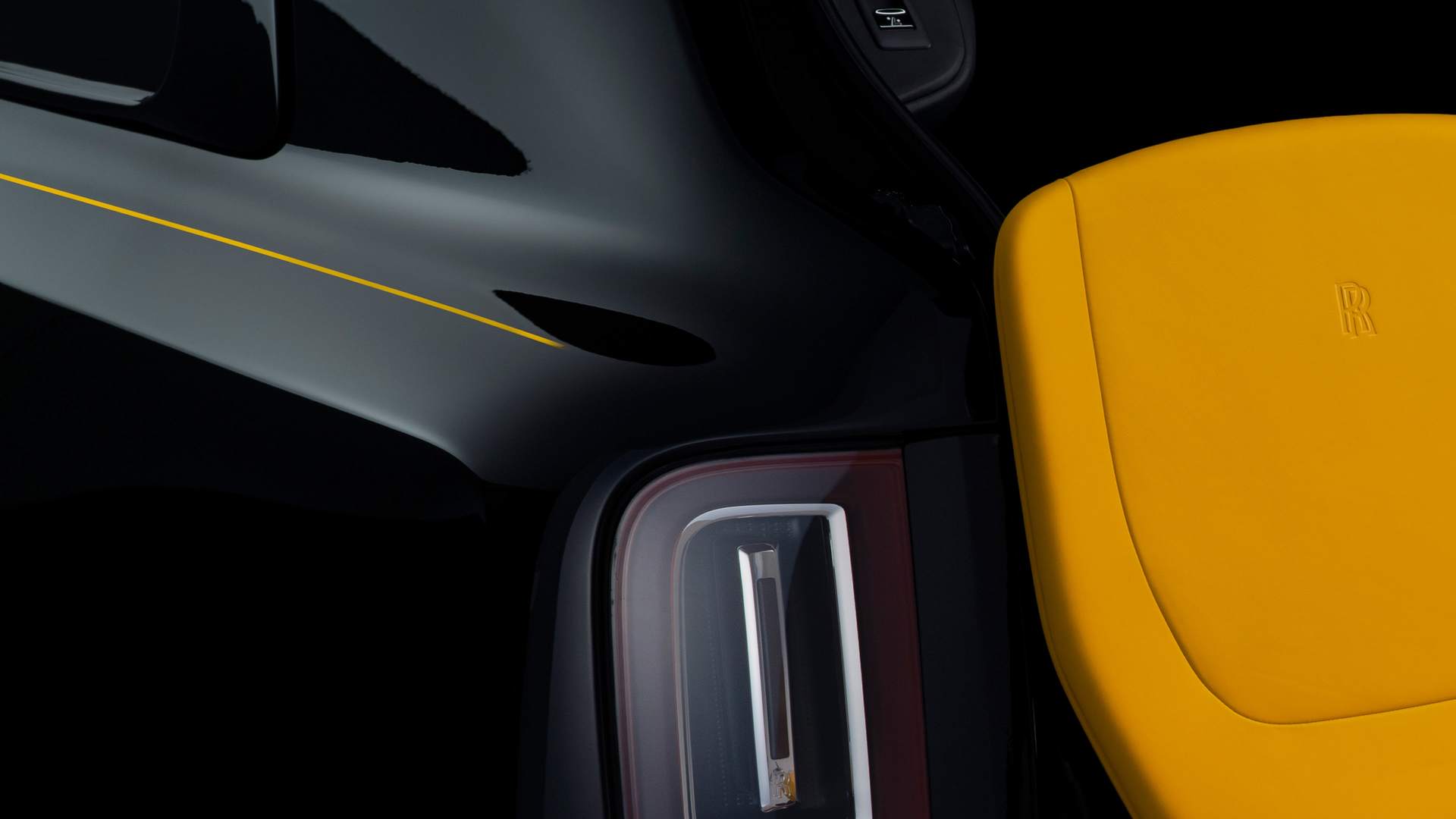 Rear close-up of the Rolls-Royce Black Badge Cullinan motor car with Forge Yellow accents and details