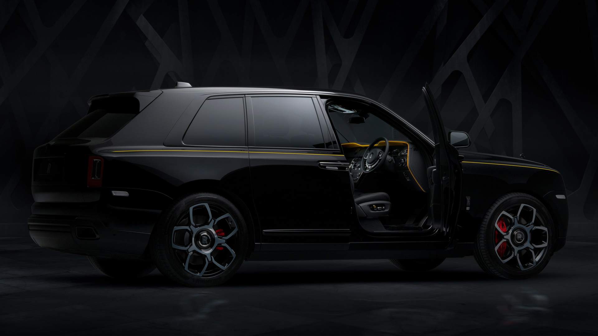 Exterior view of Rolls-Royce Black Badge Cullinan motor car with Forge Yellow accents and driver door open