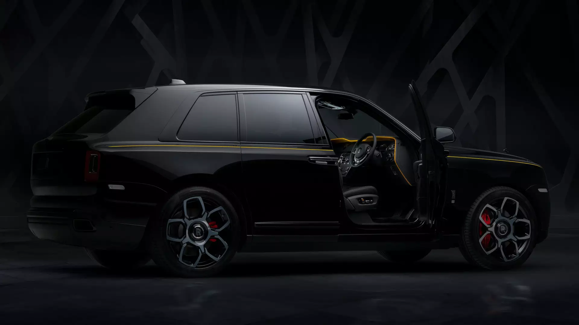 Exterior view of Rolls-Royce Black Badge Cullinan motor car with Forge Yellow accents and driver door open