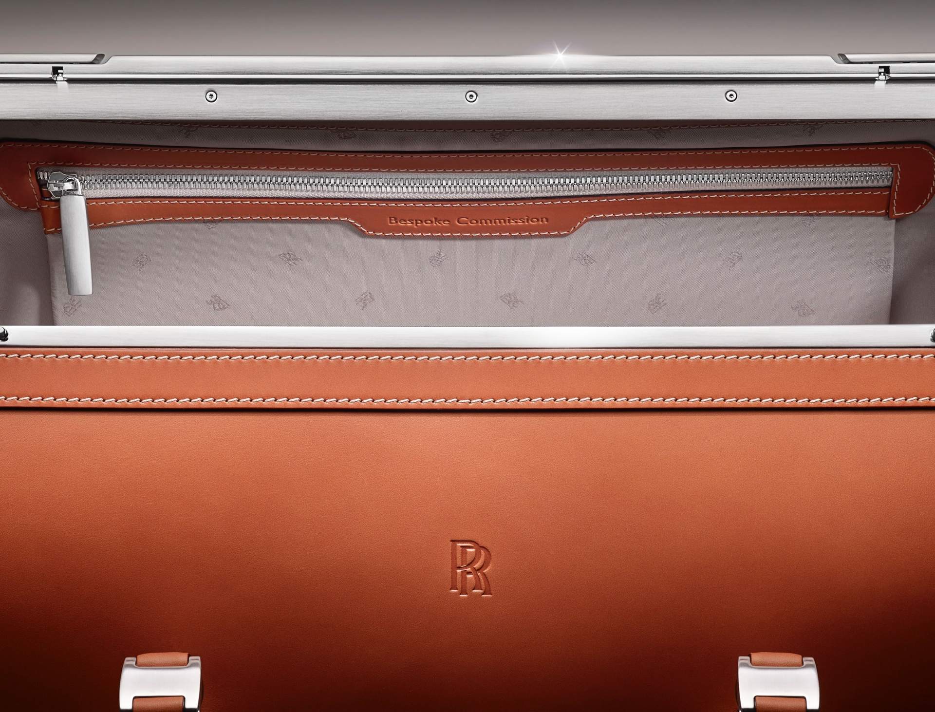 A piece from the Phantom Luggage collection. The picture showcases the small details of the bag, including the leather embossing and the RR monogram embroidery inside the bag.