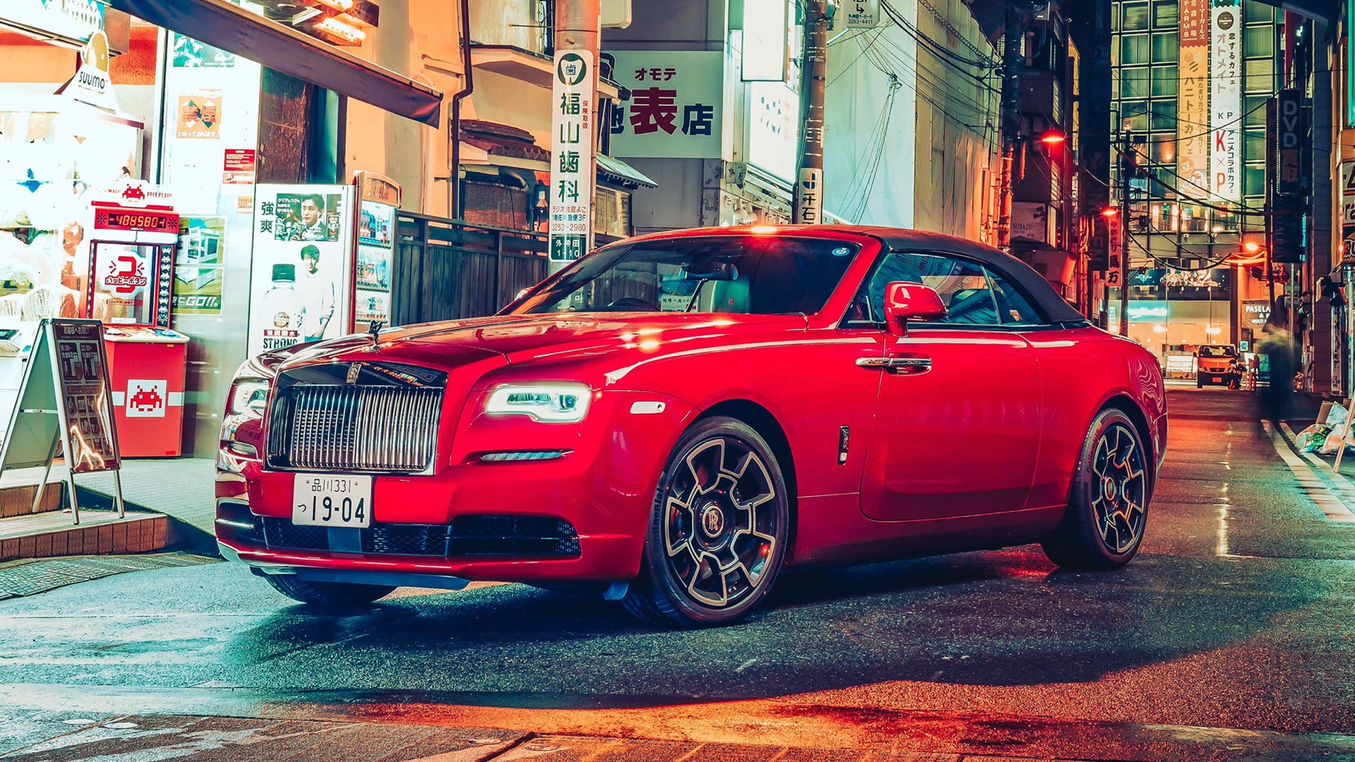 Side profile of Red Rolls Royce Wraith