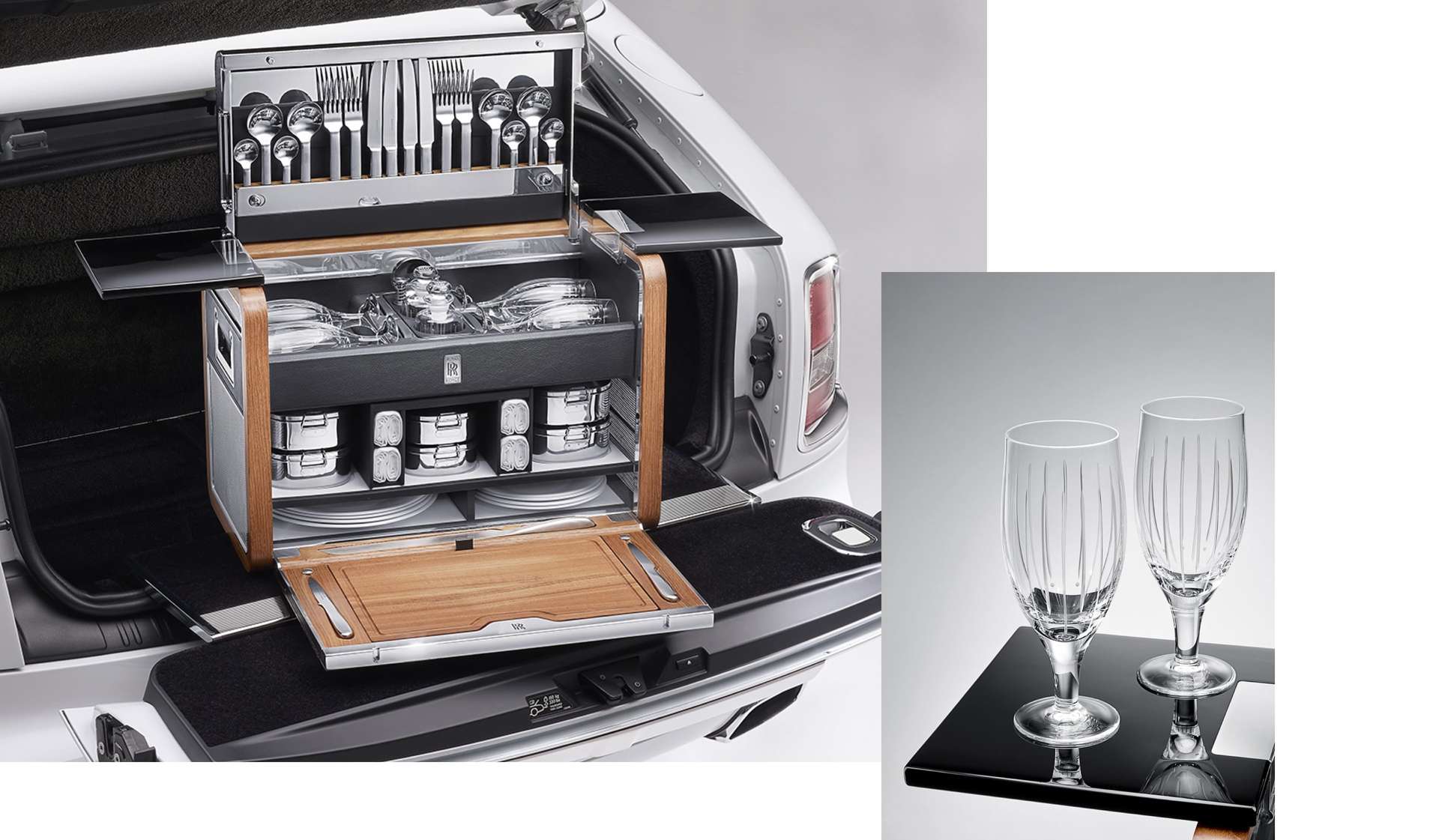 Opened Rolls-Royce luxury picnic hamper in the boot of a motor car and crystal glasses.