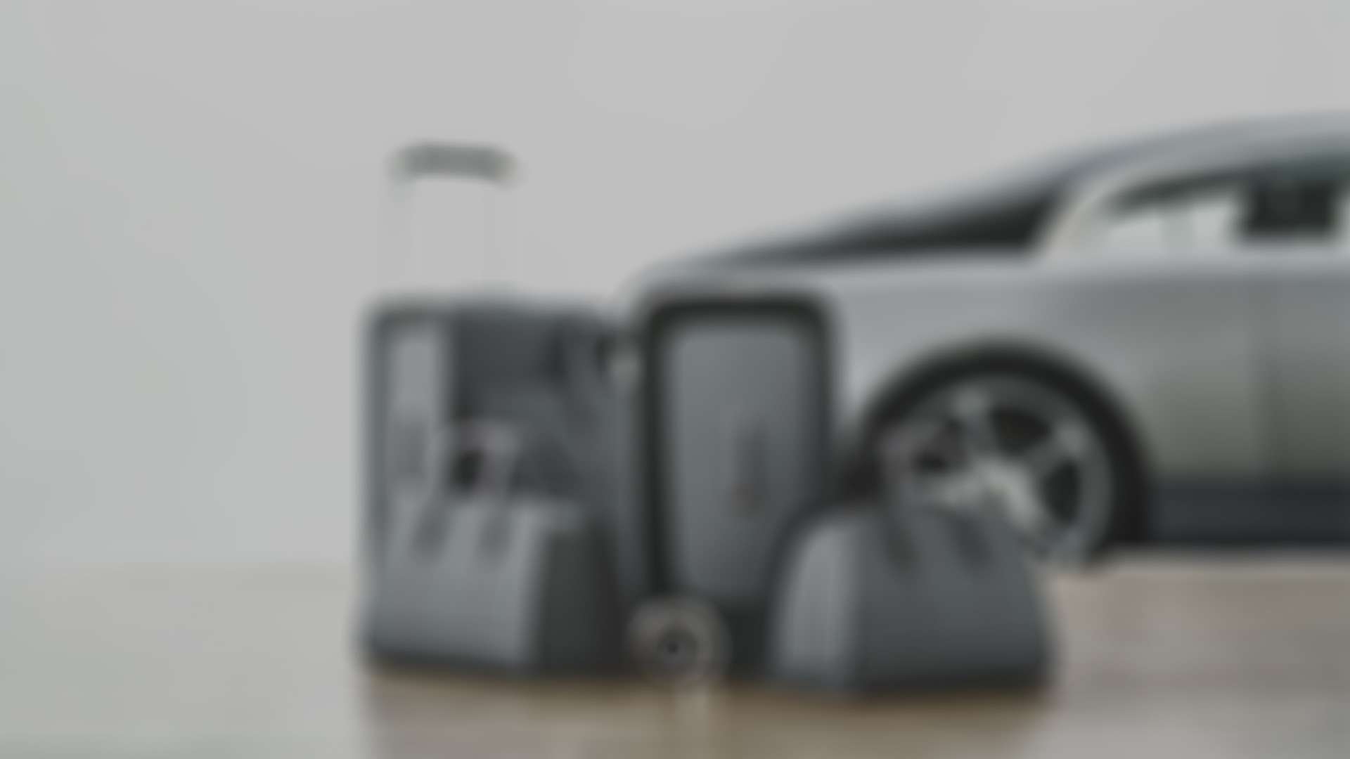 Multiple Rolls-Royce luggage bags in front of a Wraith motor car.