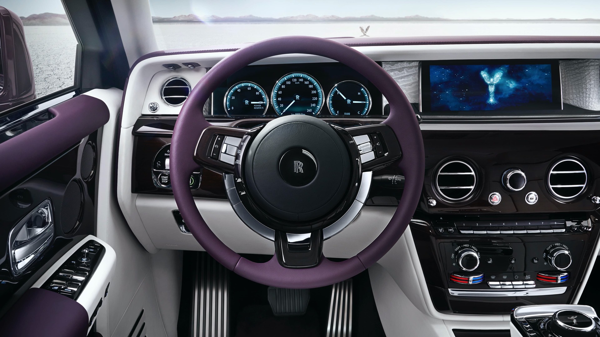 Interior view of a Rolls-Royce Phantom with a purple silk steering wheel.