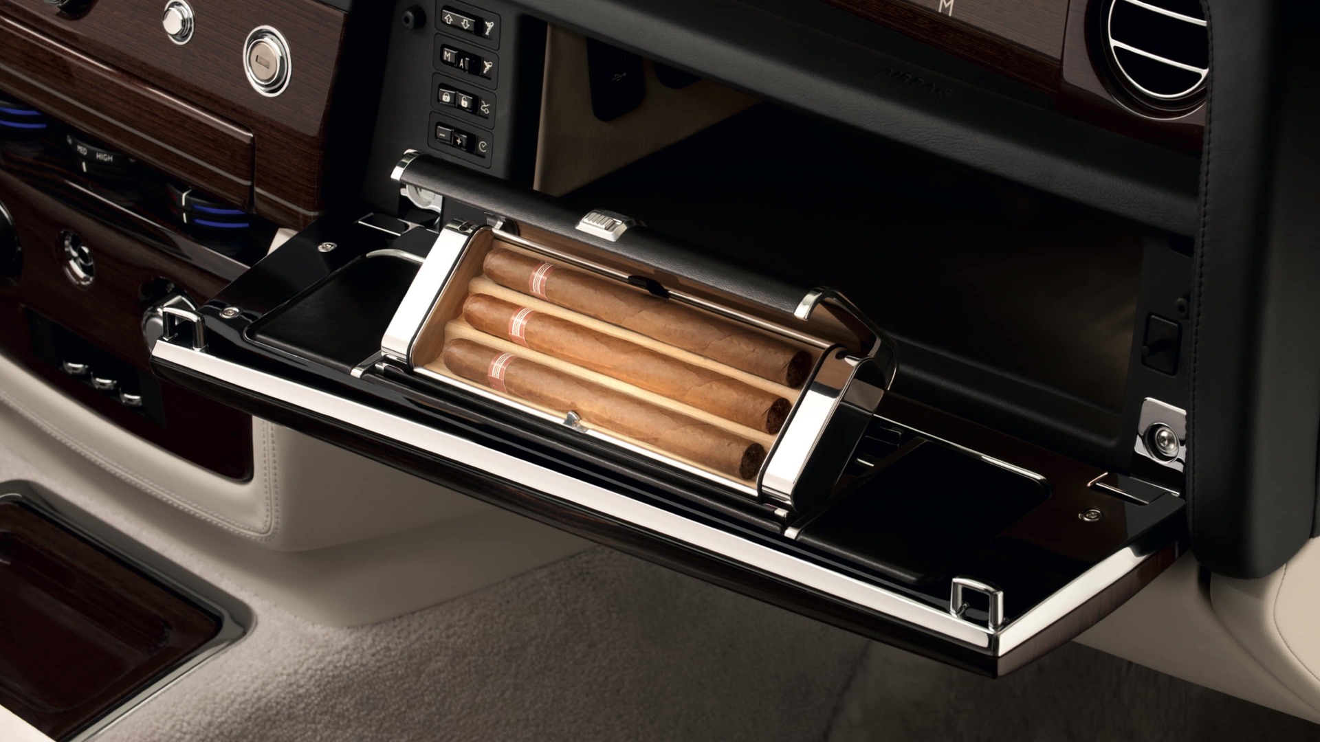 Wood-lined Humidor, beautifully trimmed with polished aluminium and leather detailing, is discreetly located within the glove box