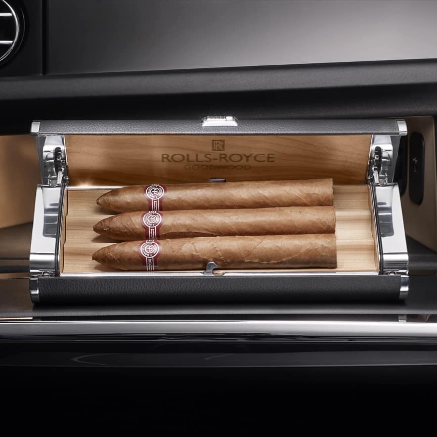 <p>木质内衬的雪茄盒以抛光铝和真皮细节精美装饰,并巧妙地安置在手套箱内。</p>