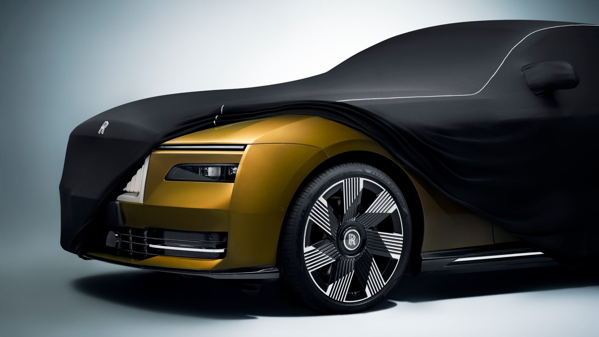 Rolls-Royce tailored indoor car cars in black colour revealing the front the a Rolls-Royce Spectre car