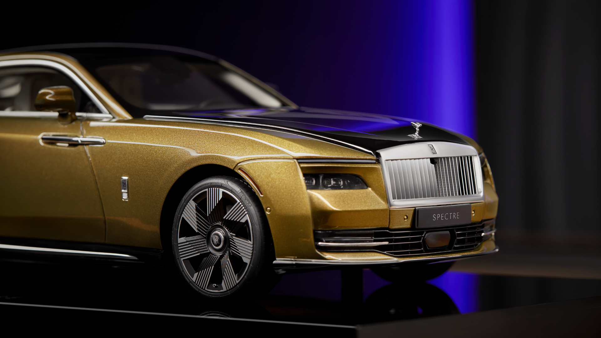 Detailed view of the Rolls-Royce Spectre replica model in gold.