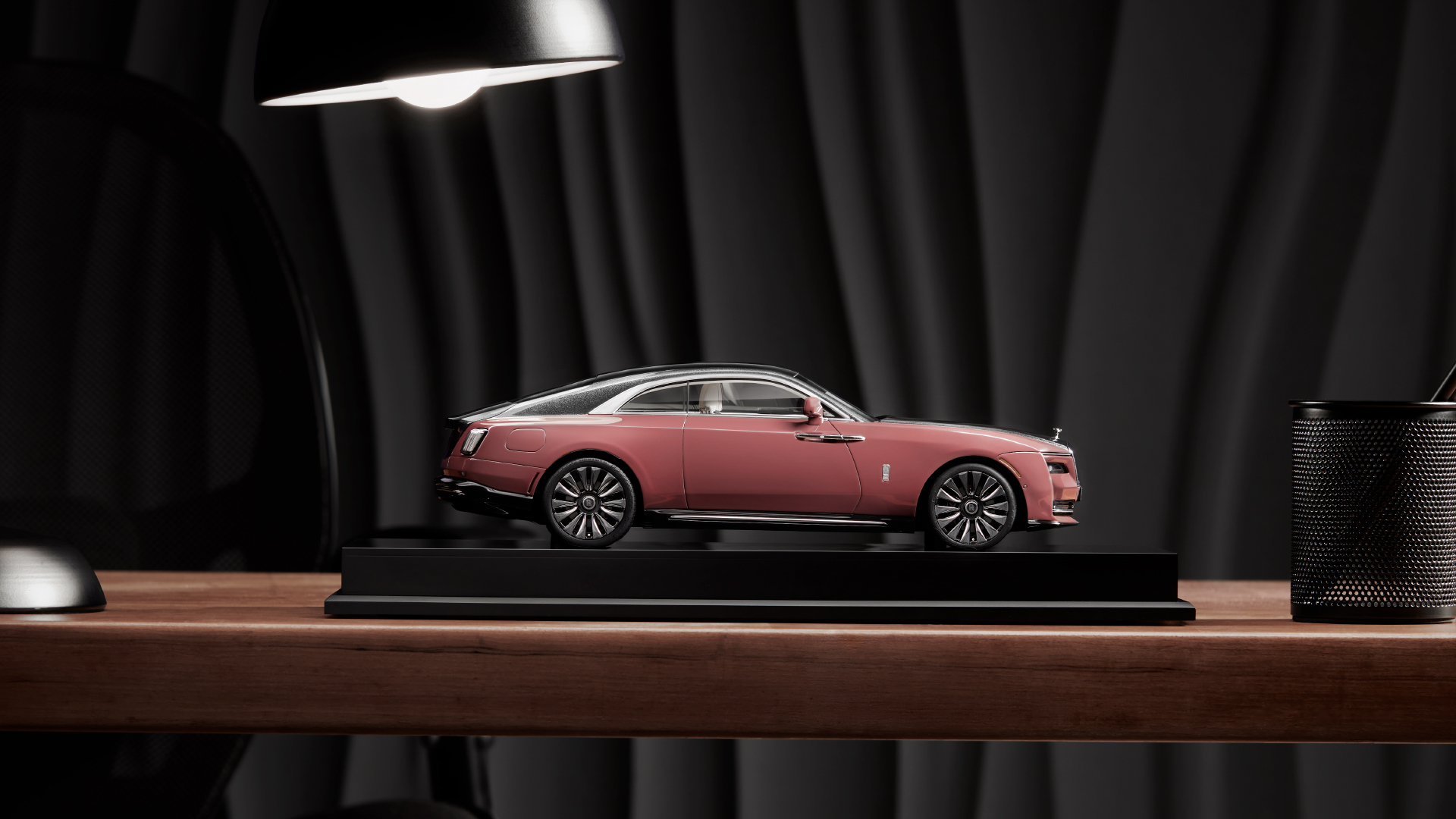 Side view of a a replica of the Rolls Royce Spectre model in gold colour