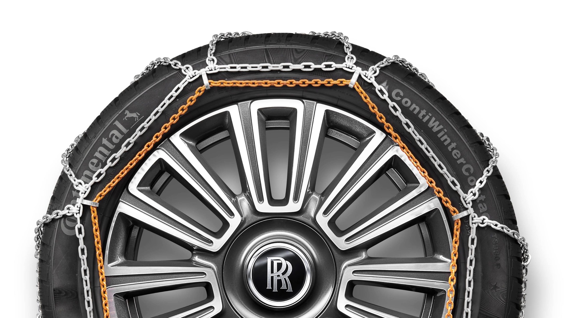 Snow chains on Rolls-Royce motor car with signature monogram on wheel