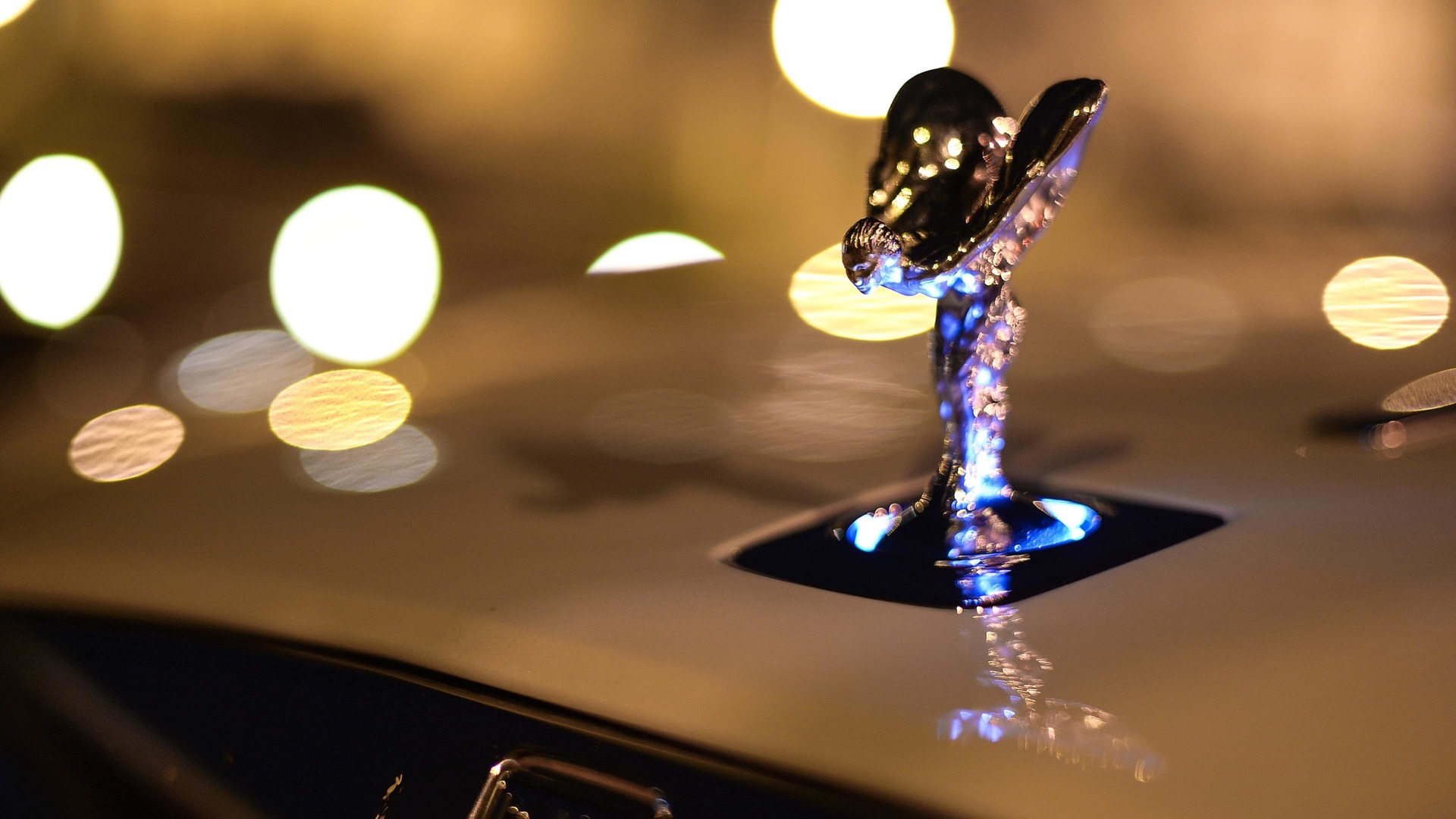 The enchanting Uplit Spirit of Ecstasy with white light halo emanating from the base of the icon