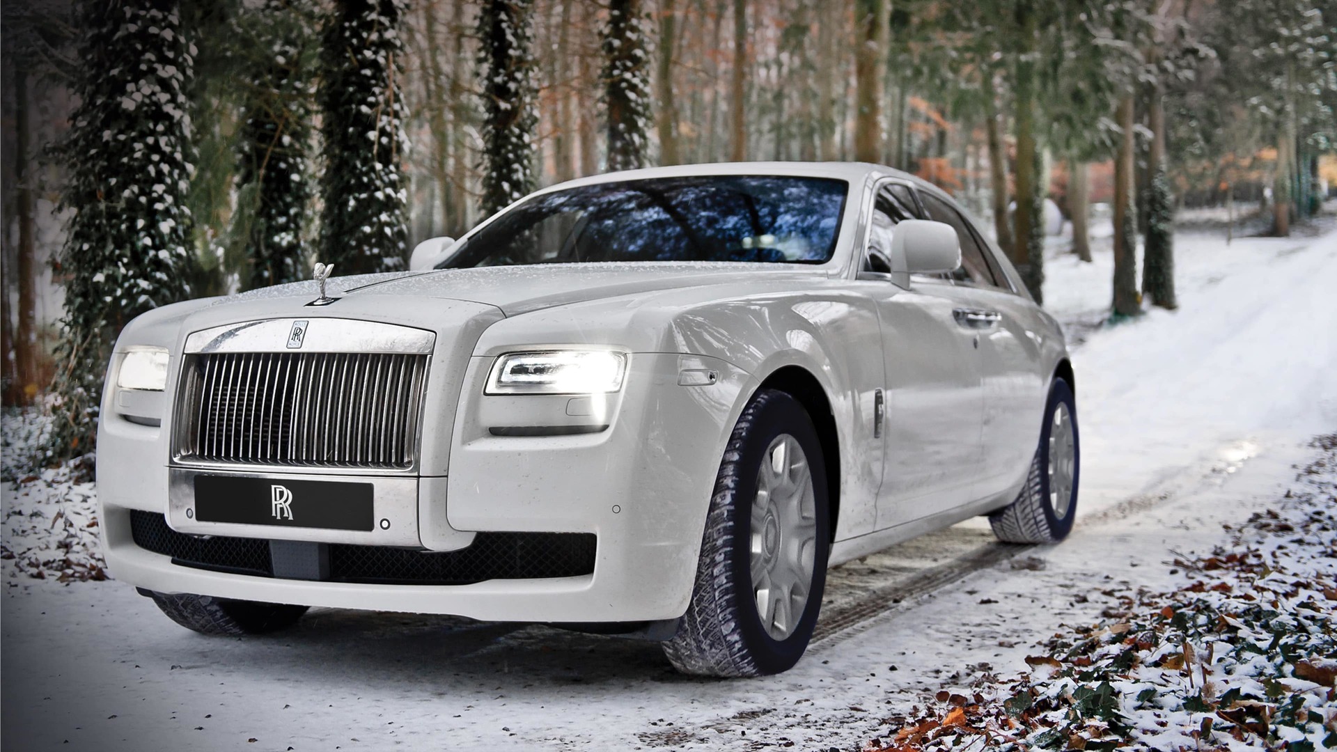 3/4 front exterior of Rolls-Royce Ghost motor car in snowy environment with Rolls-Royce 21-inch winter wheels and tyres