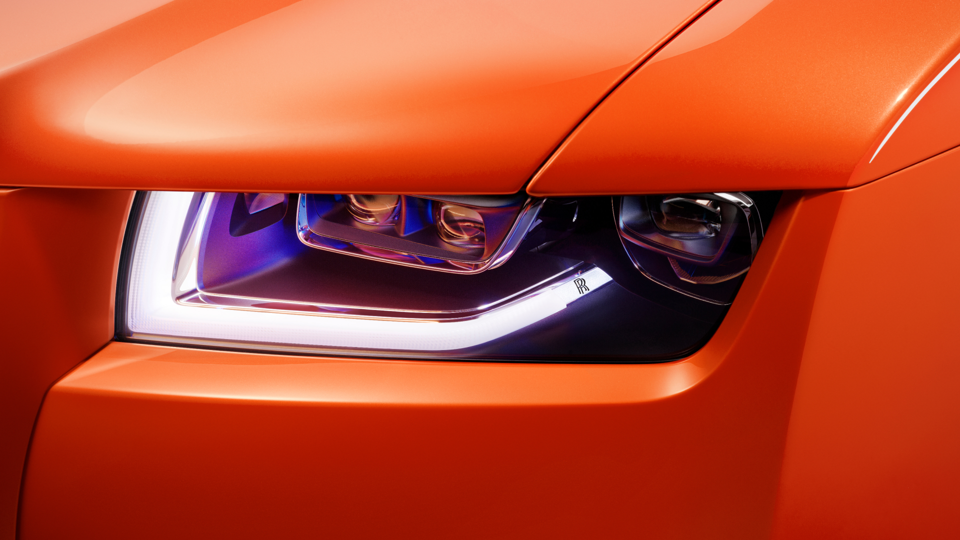 Close view of the front light of Rolls-Royce Ghost in orange 