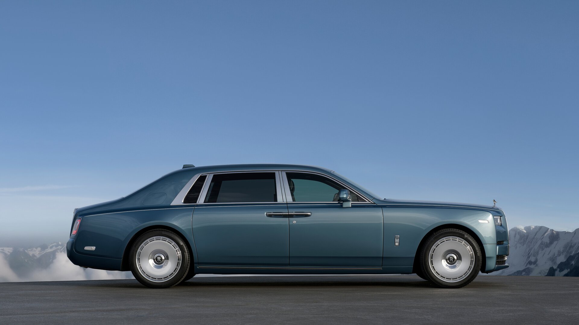Side profile of a blue Phantom Extended with mountains in the background.
