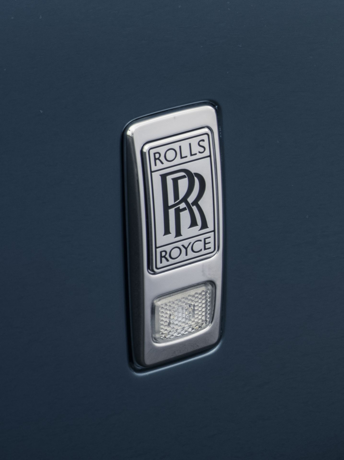 Rolls-Royce Phantom Extended silver badge close up shot.