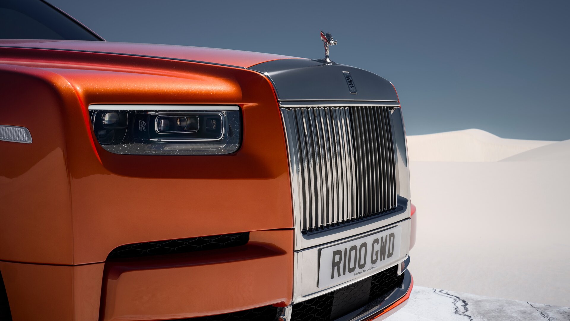 Close up of an Orange Phantom grille and headlights on a slab of marble in the middle of the desert