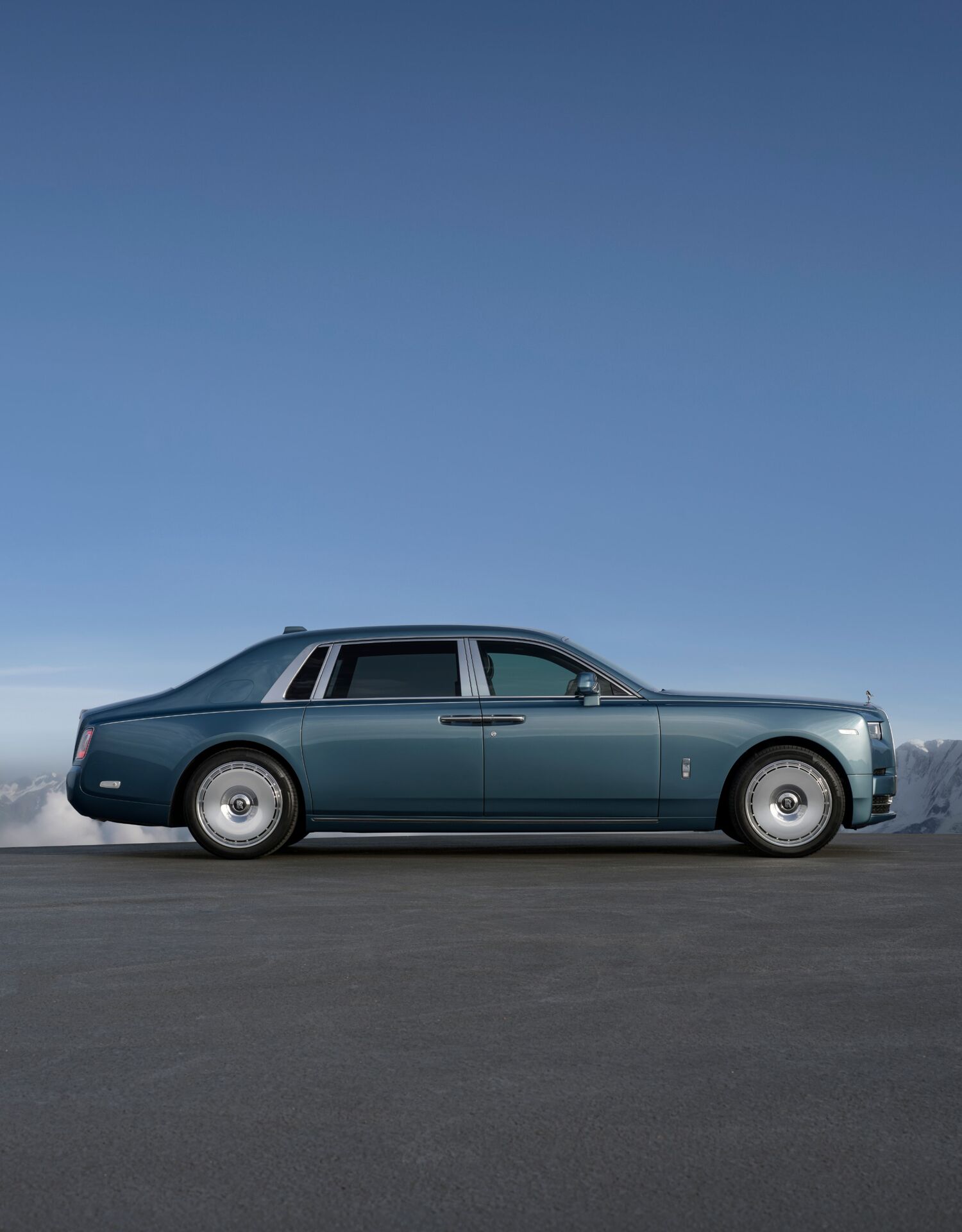 Side profile of a blue Phantom Extended with mountains in the background