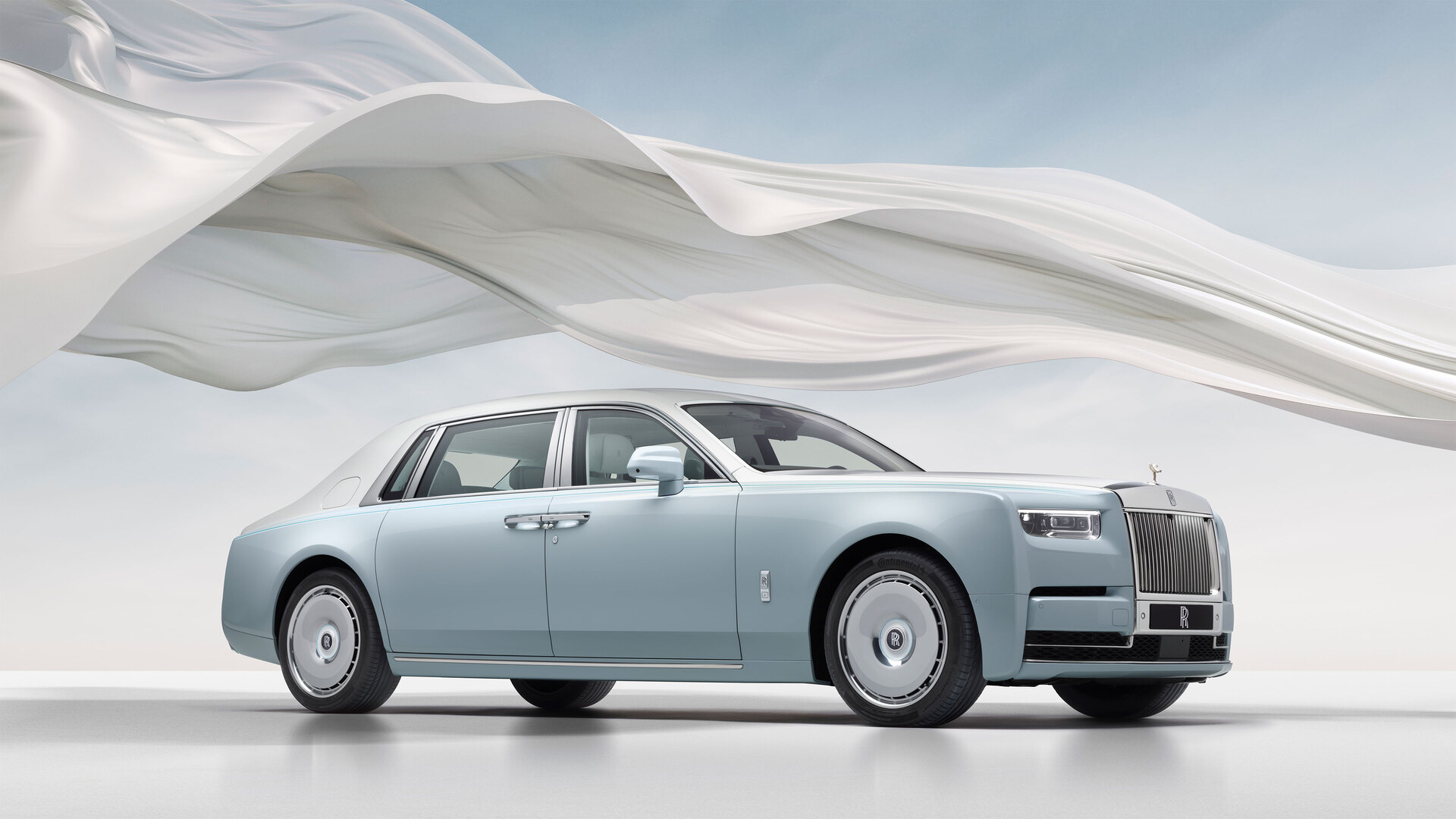 Phantom Scintilla full car image with the white ribbon circling it with the blue sky in the background.