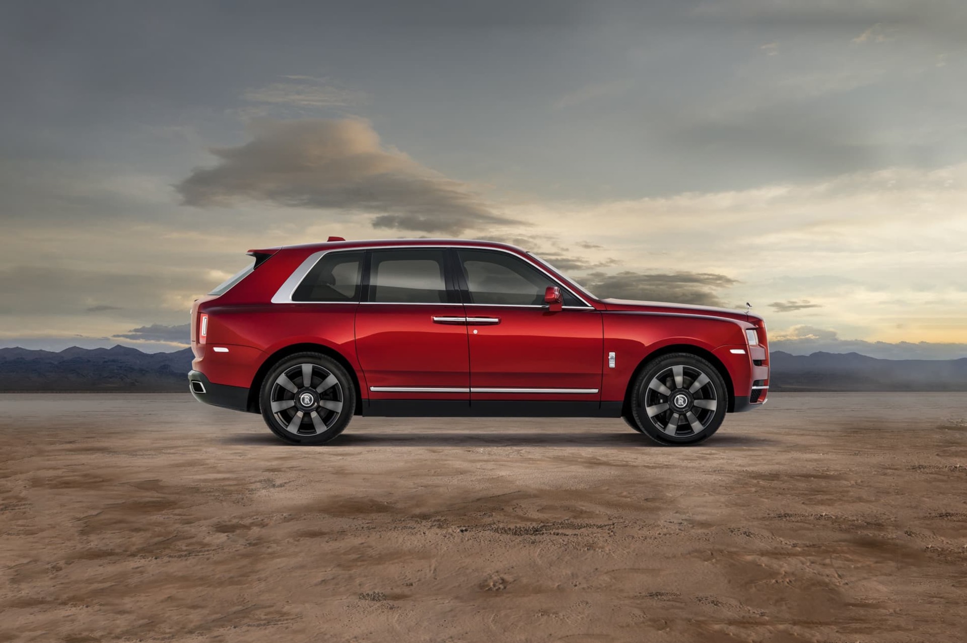 Side exterior view of the Rolls-Royce Cullinan motor car stationary in expansive plains setting
