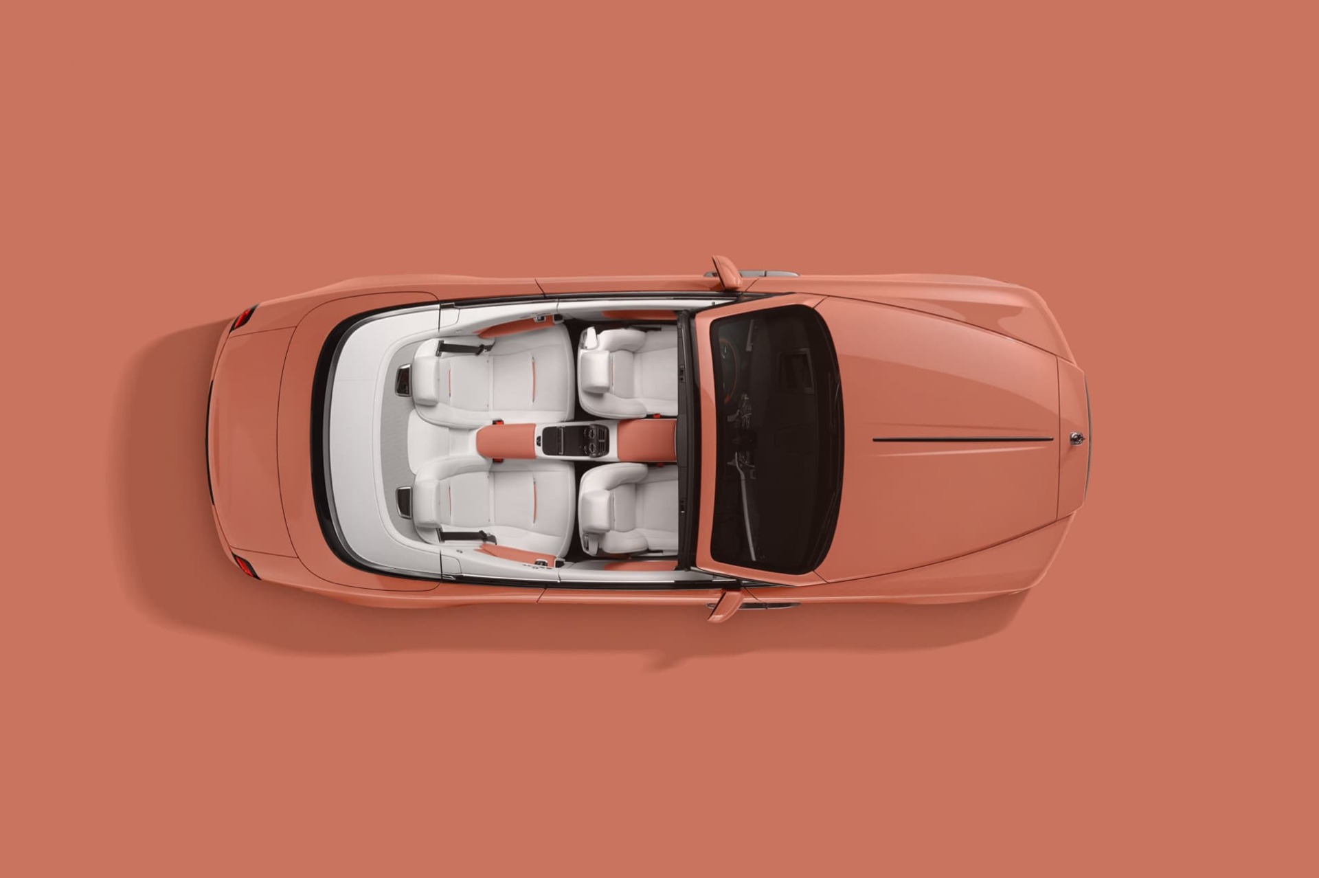 Aerial view of Rolls-Royce Dawn motor car in Coral from the Pebble Beach Pastel colour collection
