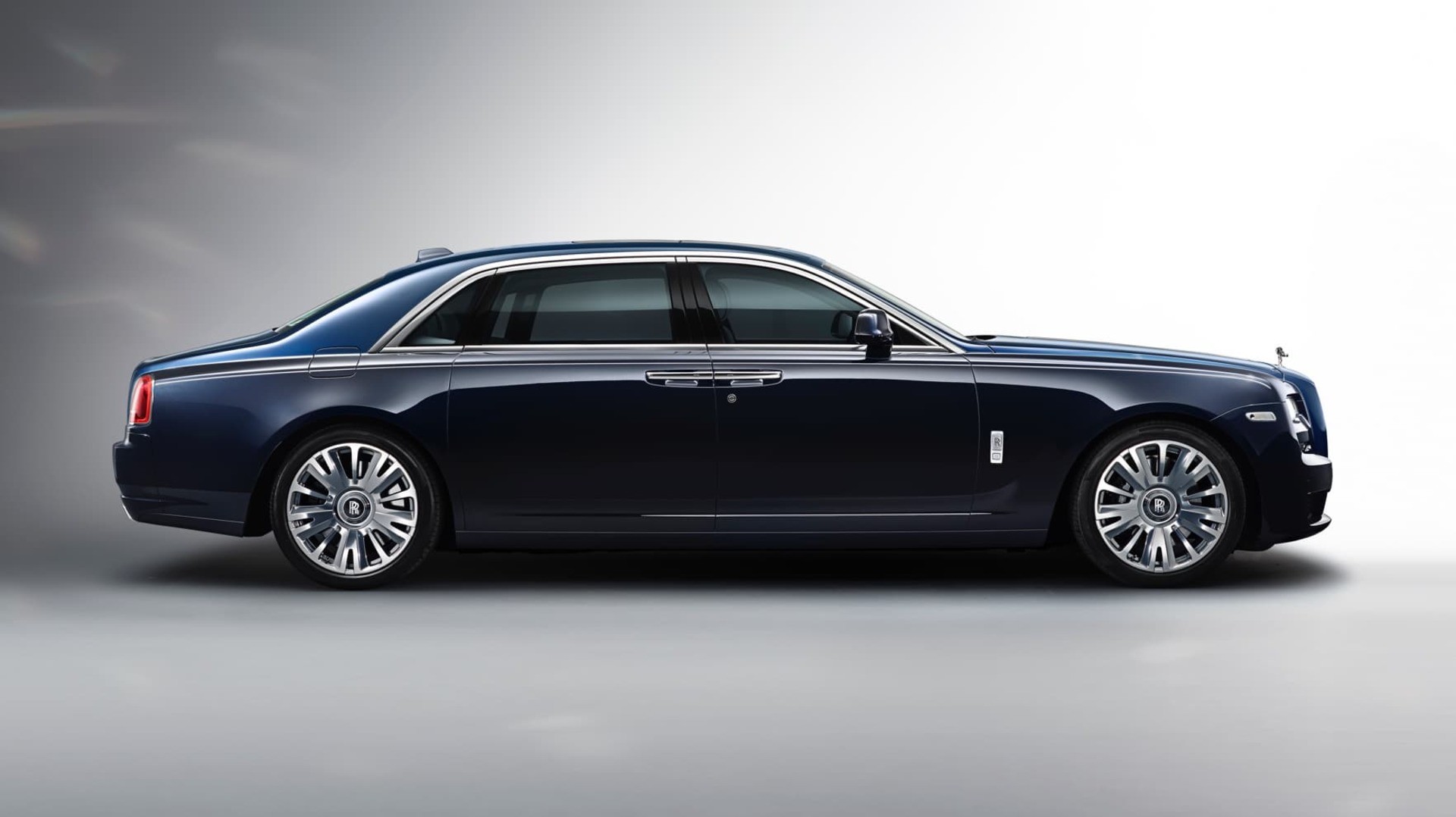 A side profile shot of a dark blue Rolls-Royce Ghost Extended