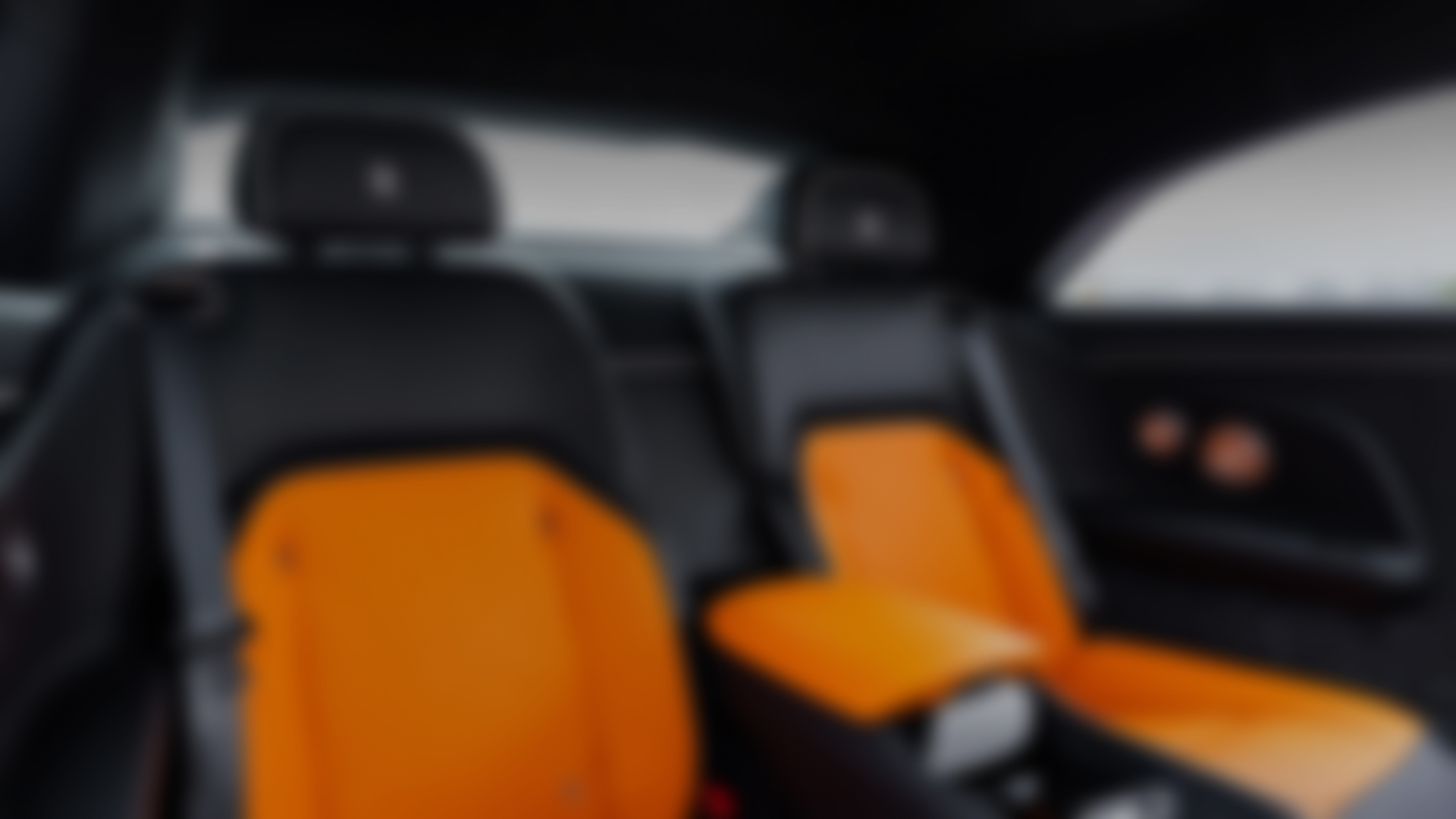 Interior shot of  Spectre carseats, they are black and orange.