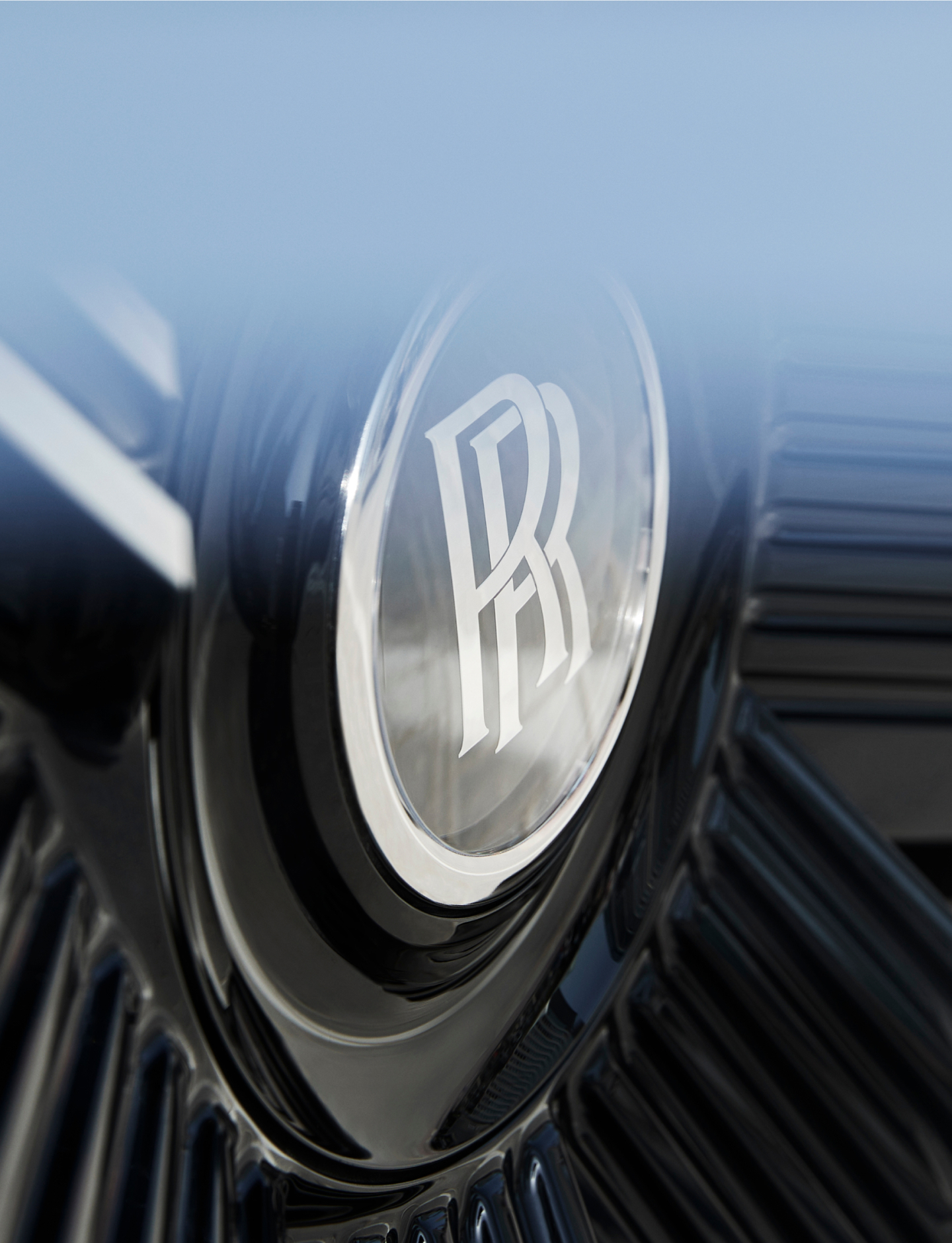 Close up of the Rolls Royce logo sitting on a Spectre wheel.