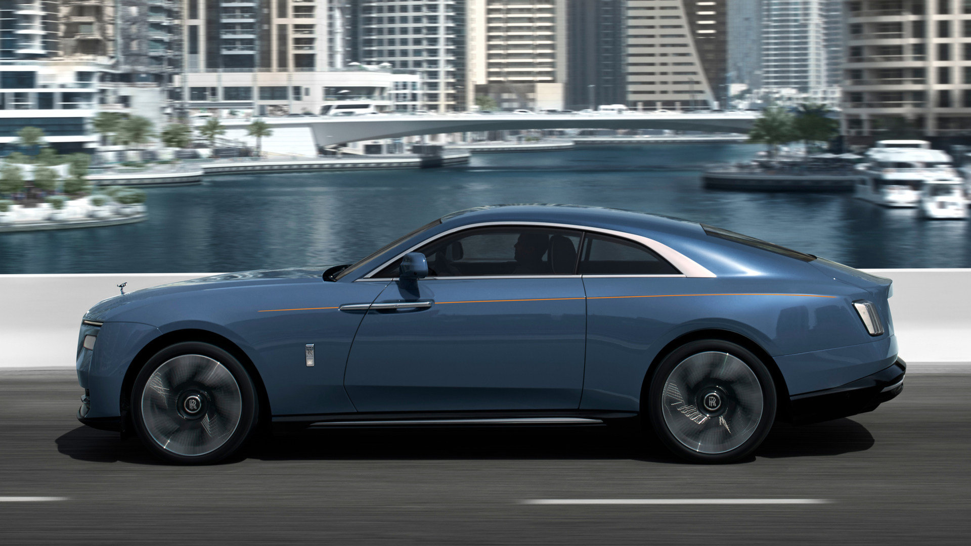 Side view of the Rolls-Royce Spectre car driving in the city
