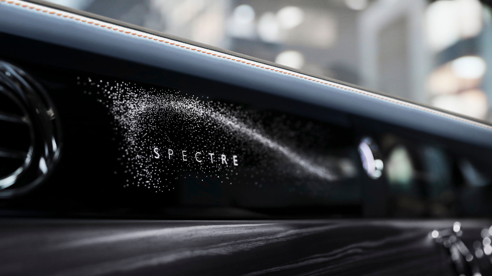 Spectre logo writing on the dashboard of inside of the car. 