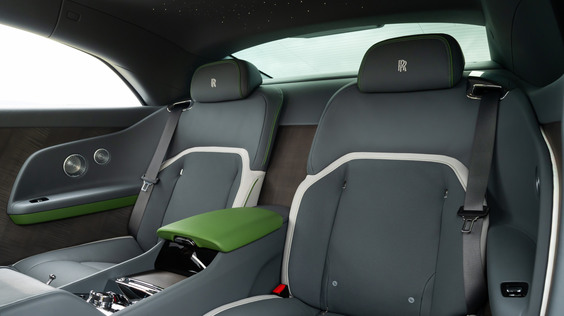 Interior shot of  Spectre carseats, they are black, white, and green.