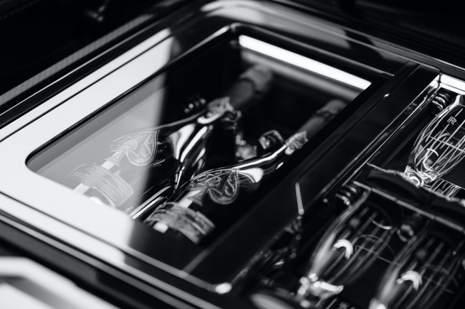 black and white image of the champagne and glasses in the back of the Boat Tail
