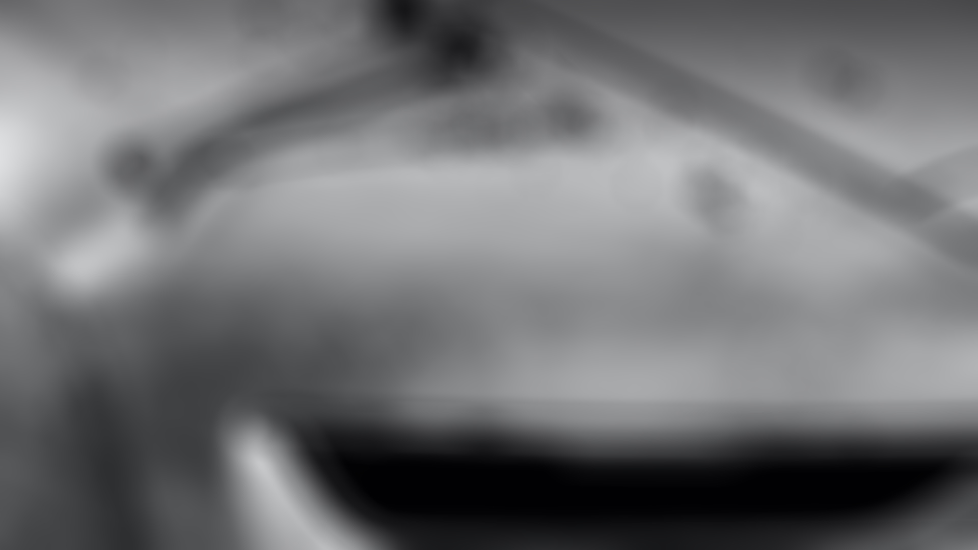 black and white image of the Boat Tail being created with hammers on top of the bonnet 