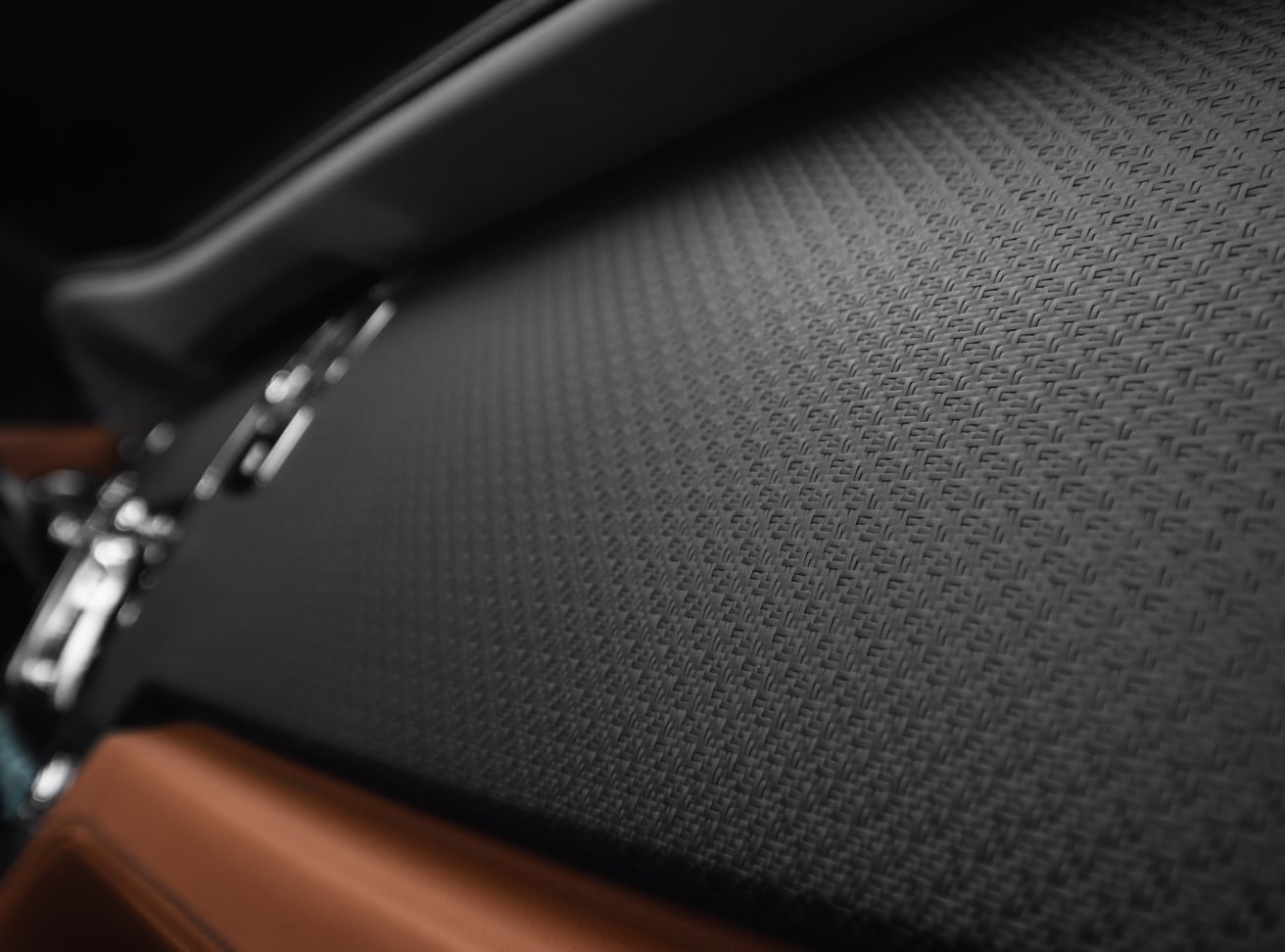 Dashboard detail of the Rolls-Royce Dawn Silver Bullet motor car, crafted with intricately woven strands of carbon fibre with open-pore, matte finish