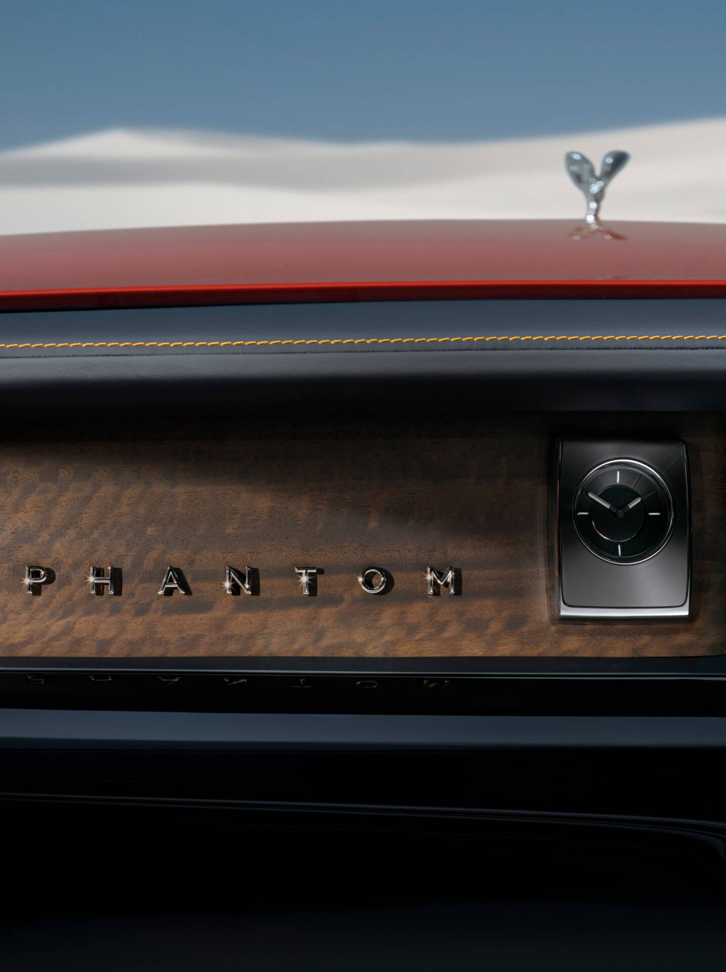 Interior image of the Phantom, looking out the front wind-screen with the SOE and desert in the background. "Phantom" positioned against a wood fascia and interior clock