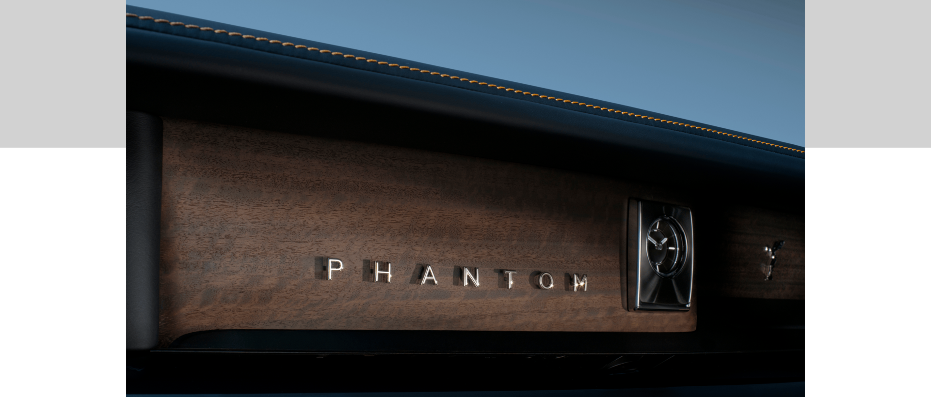 Interior image of the Phantom with "Phantom" positioned against a wood fascia and clock revealed